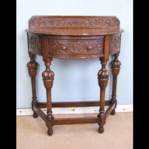 Antique Jacobean Style Carved Oak Demi Lune Side Table. This lovely carved oak demi lune / side table has a low carved upstand to the back and carved detail to the top edge
