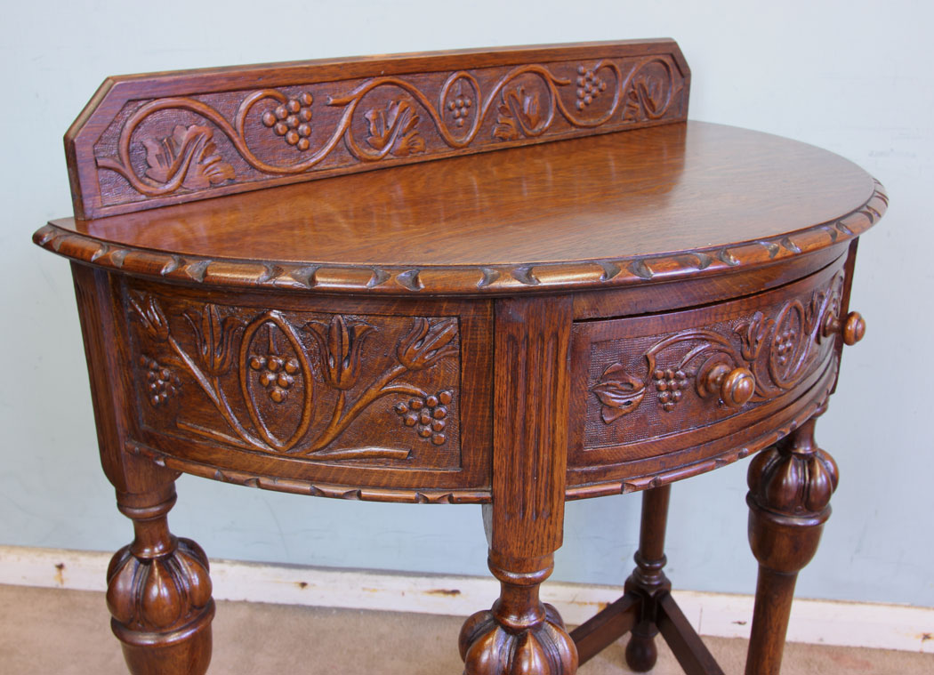 11375r4 Antique Oak Demi Lune Side Table, Antique Jacobean Style Carved Oak Demi Lune Side Table. This lovely carved oak demi lune / side table has a low carved upstand to the back and carved detail to the top edge