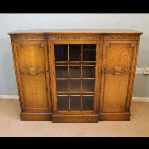 Antique Breakfront Oak Cabinet Bookcase. This quality oak breakfront bookcase cabinet has a solid oak top with moulded edge under having carved detail.